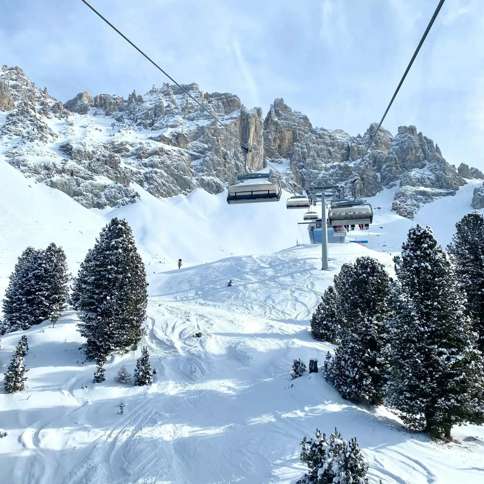 Ski lift ascending a snow-covered mountain, with chairlifts or gondolas operating in winter.