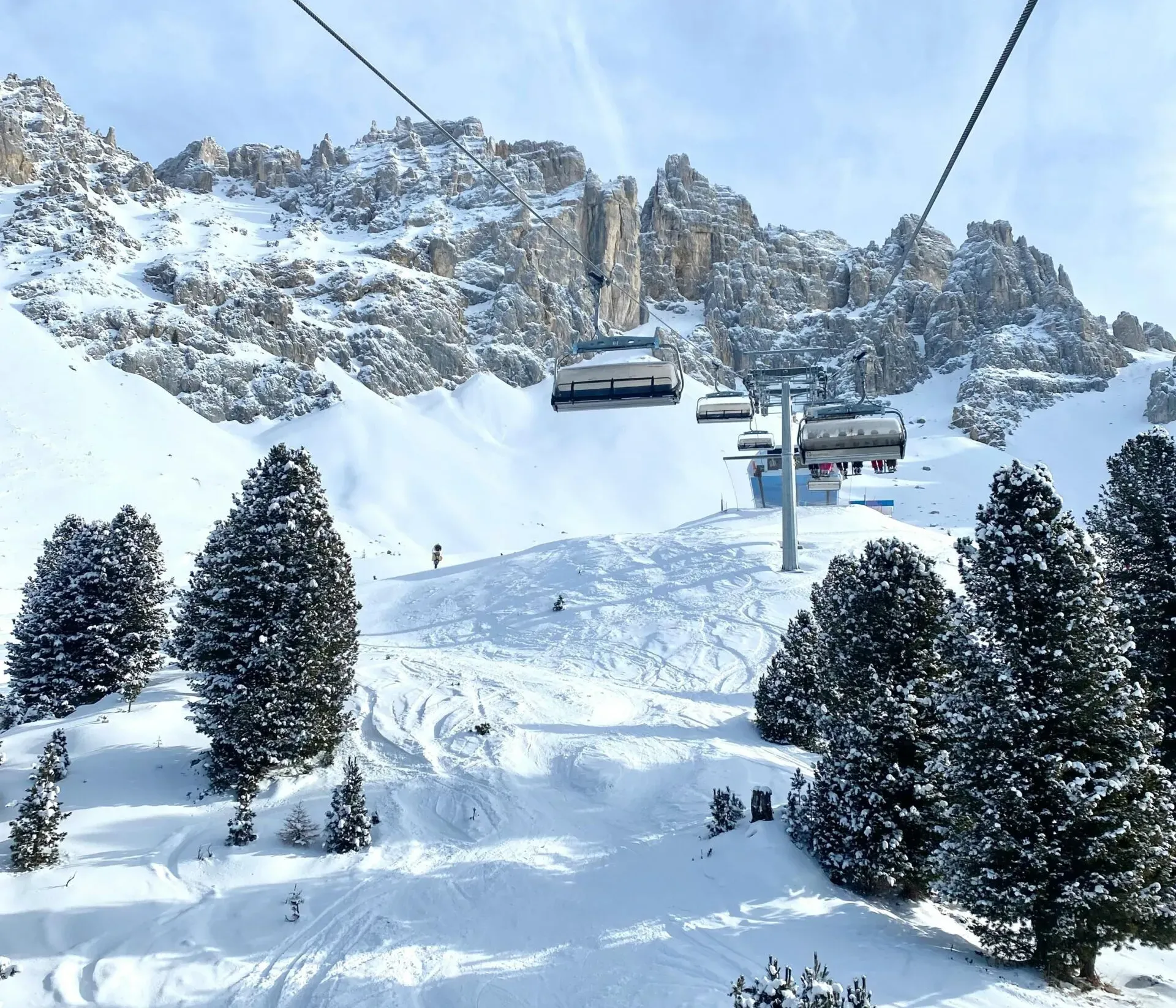 Ski lift ascending a snow-covered mountain, with chairlifts or gondolas operating in winter.
