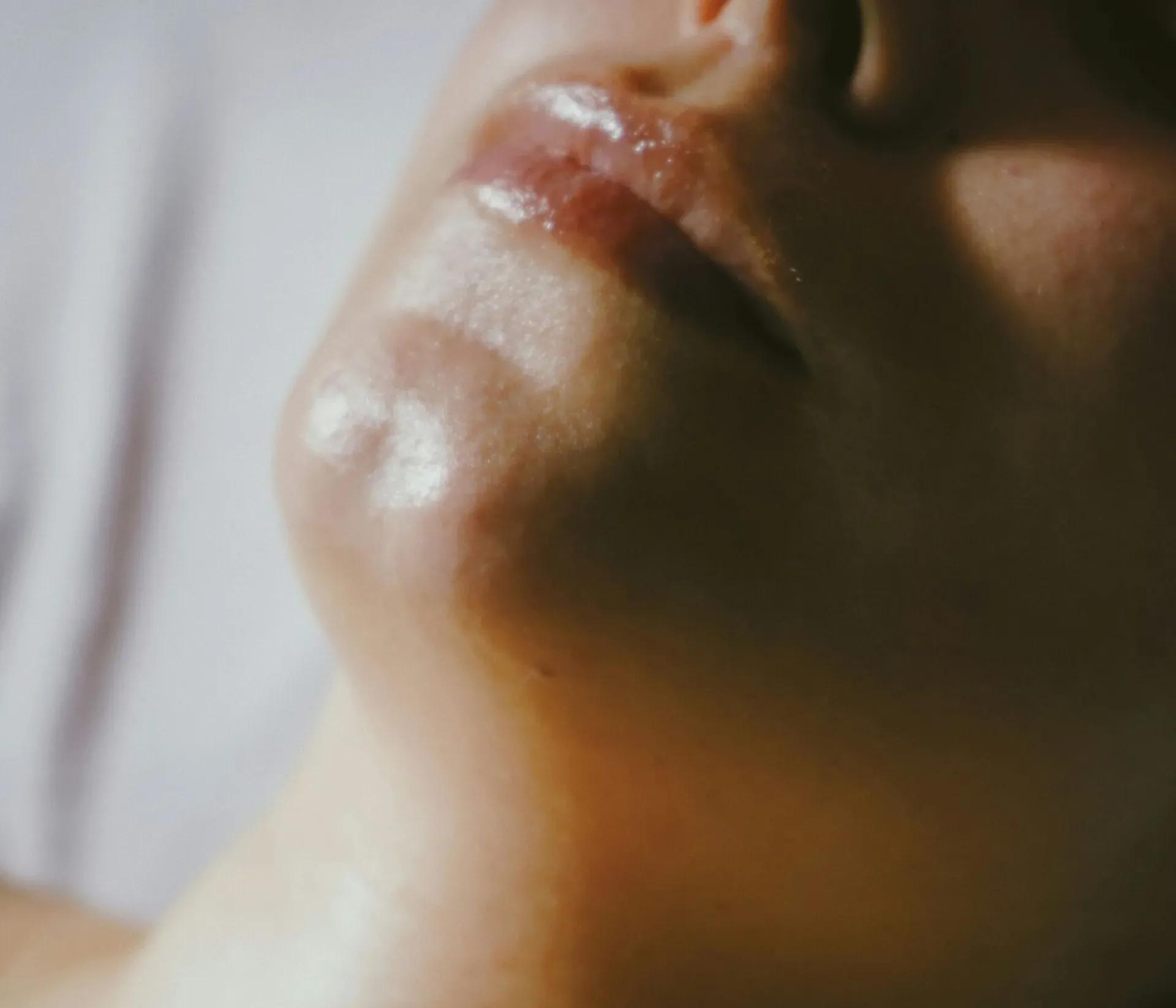 Close-up of a woman’s face during a facial massage.
