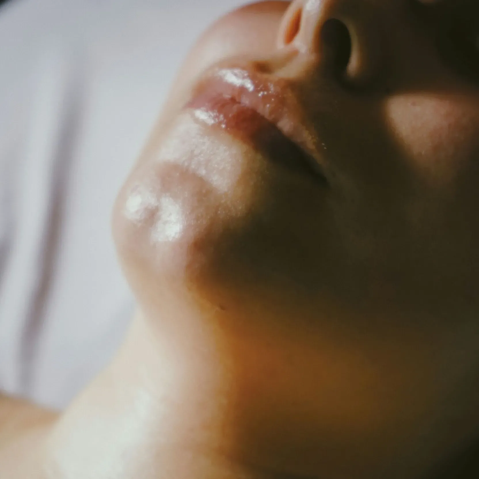 Close-up of a woman’s face during a facial massage.