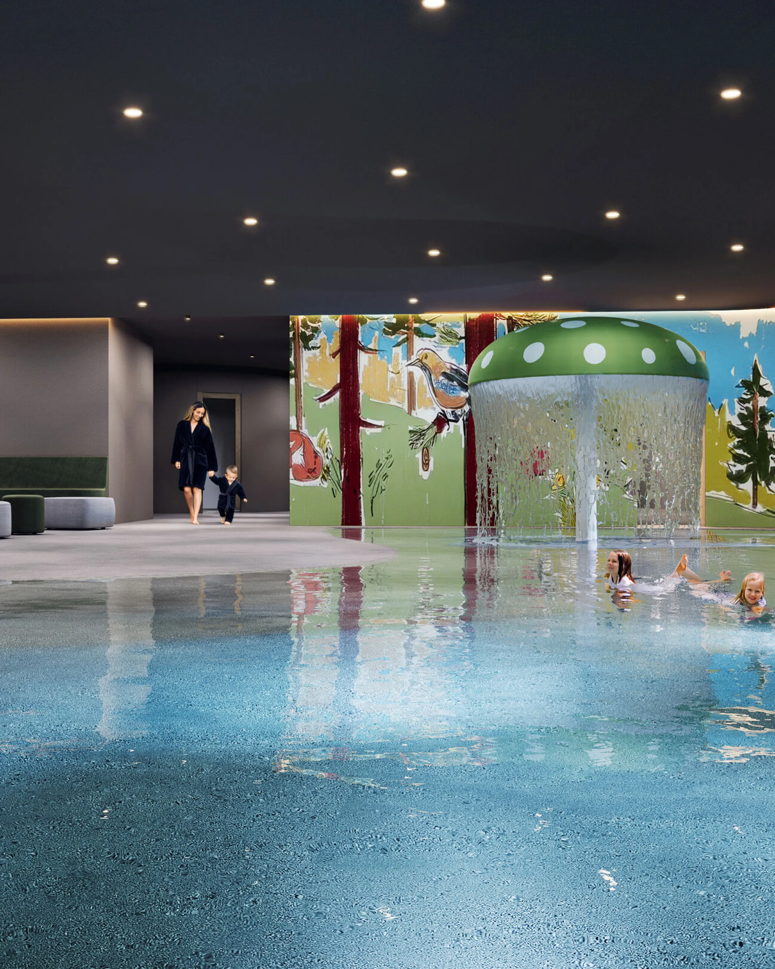 Children's pool with a large green mushroom at the center pouring a fun water cascade, surrounded by a mural of mountains and forest animals; two girls are playing in the water while a mother enters holding her child's hand, with comfortable poufs in the foreground for seating.