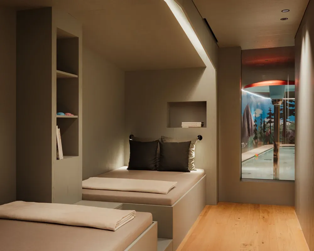 Modern, minimalist interior with built-in seating and neutral tones. A window reveals an indoor pool area, creating a serene and luxurious ambiance.